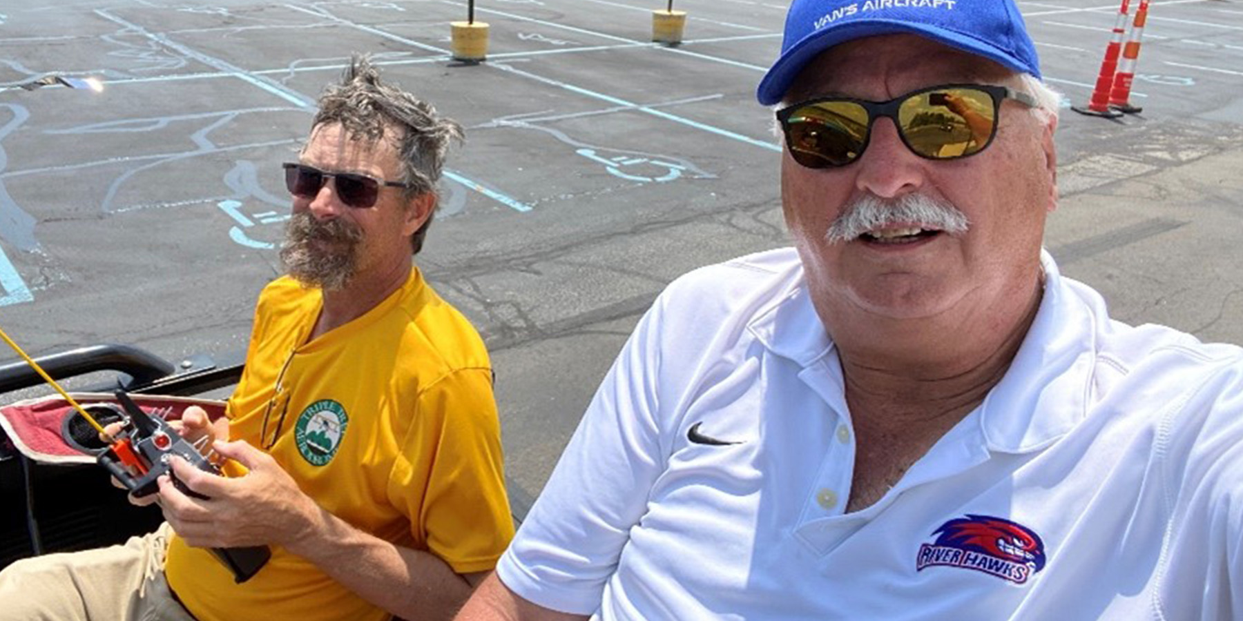 Here is Ed Dumas (right) and his spotter, Wally “By Golly” Adasczik, in the back of Wally’s country Cadillac heading out on the 