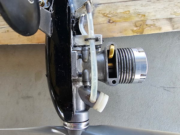 A bottom view of the K&B 40 engine with shutoff and primer tube installation for instant restarts.