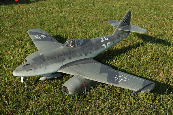 Model WWII German fighter jet on grass.