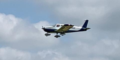 4.	Mark Radcliff’s Piper Cherokee on a flyby.