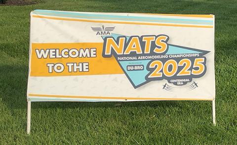 Welcome sign for the National Aeromodeling Championships 2025 on a lawn.