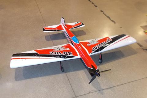 Remote-controlled red plane with white wings, blue cockpit, and "Police" on the wings.