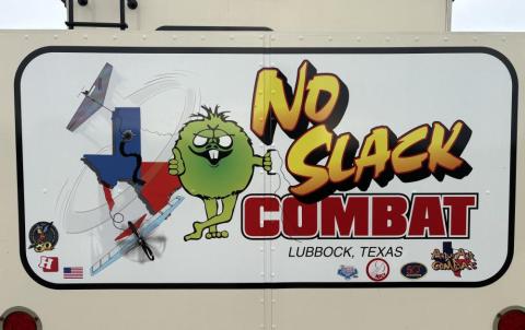 Cartoon aircraft and creature with "No Slack Combat" text on a sign, Lubbock, Texas.