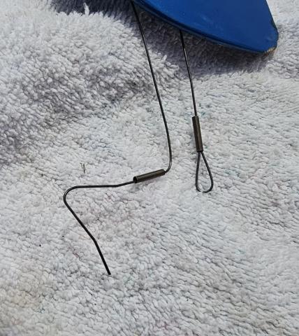 Fishing line and swivel on a towel.