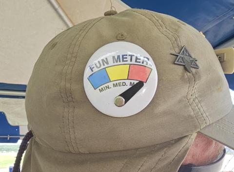 Khaki cap with a fun meter button showing high.