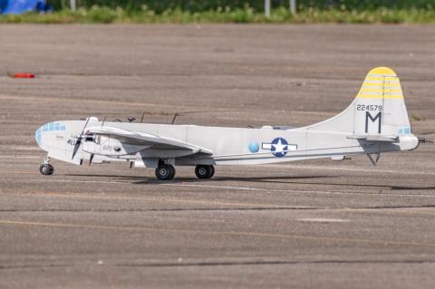 Model airplane on tarmac with vintage military design.