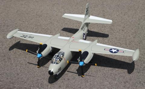 A scale model of a military aircraft with U.S. markings on a concrete surface.