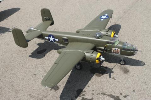 A model of a military aircraft with olive green body and star insignia.