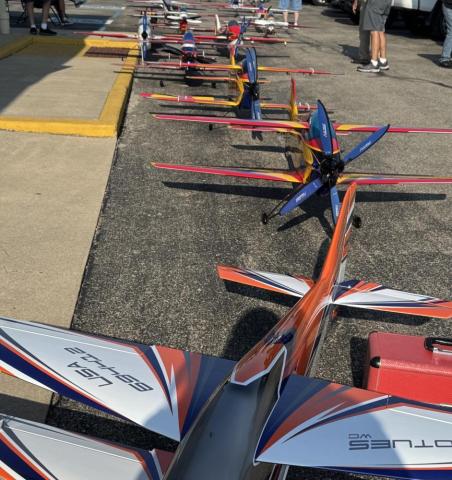 Model airplanes displayed on a paved surface, with vibrant colors and patterns.