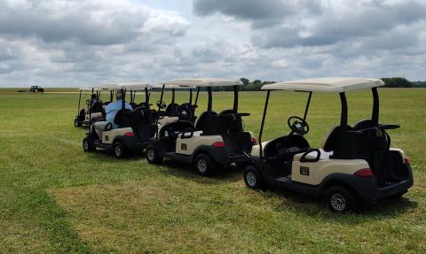 Returning the golf carts to the farm house. Returning the golf carts to the farm house.