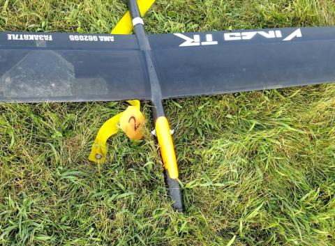 Black and yellow model plane on grass.
