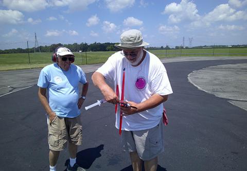 Bill Hughes fueling his 21 Sport Speed plane. Dave Rigotti looks on ready to help with the starting duties.