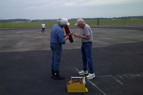 Glen Van Sant holding Henry Nelson’s 21 Proto so it can be fueled for another try at going faster!